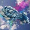 Hand dyed superwash extra fine Merino top. ‘Schapenwolkjes’. Soft roving with sky blue stripes on a white base.