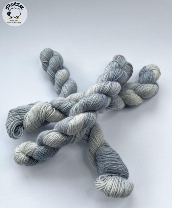 il_fullxfull.6864515773_cq2b.jpg Hand dyed superwash superfine Merino, Alpaca and mulberry silk fingering weight yarn. Ombre steel grey.