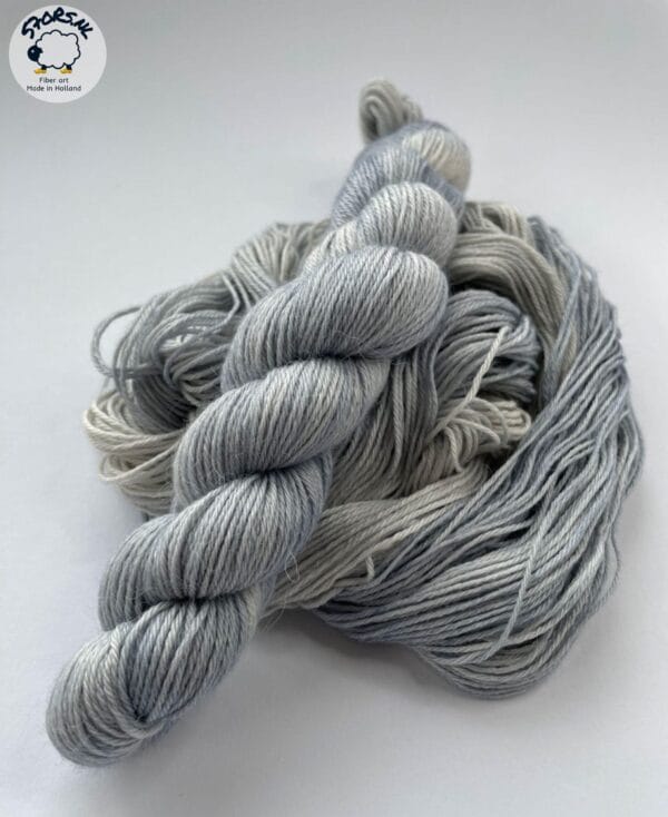 il_fullxfull.6864515887_cccg.jpg Hand dyed superwash superfine Merino, Alpaca and mulberry silk fingering weight yarn. Ombre steel grey.