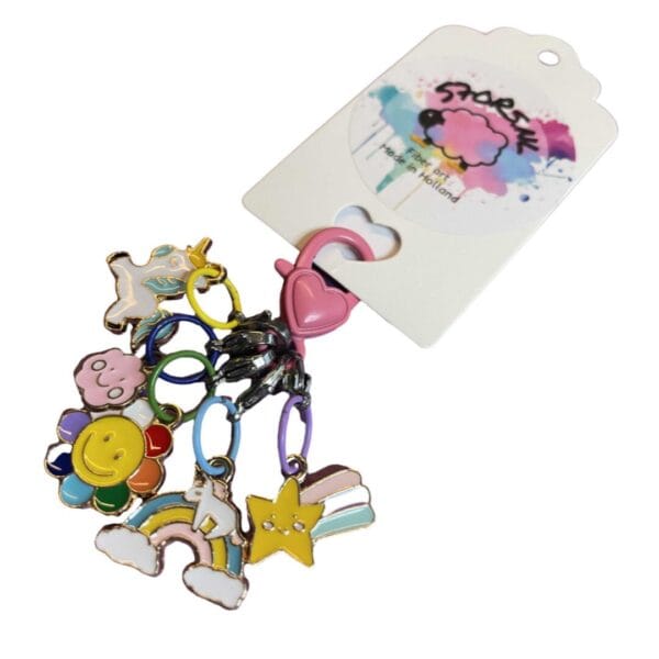 Five metal stitch markers with colorful enamel decorations.