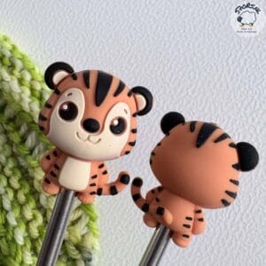 Gnome needle stoppers for knitting needles.